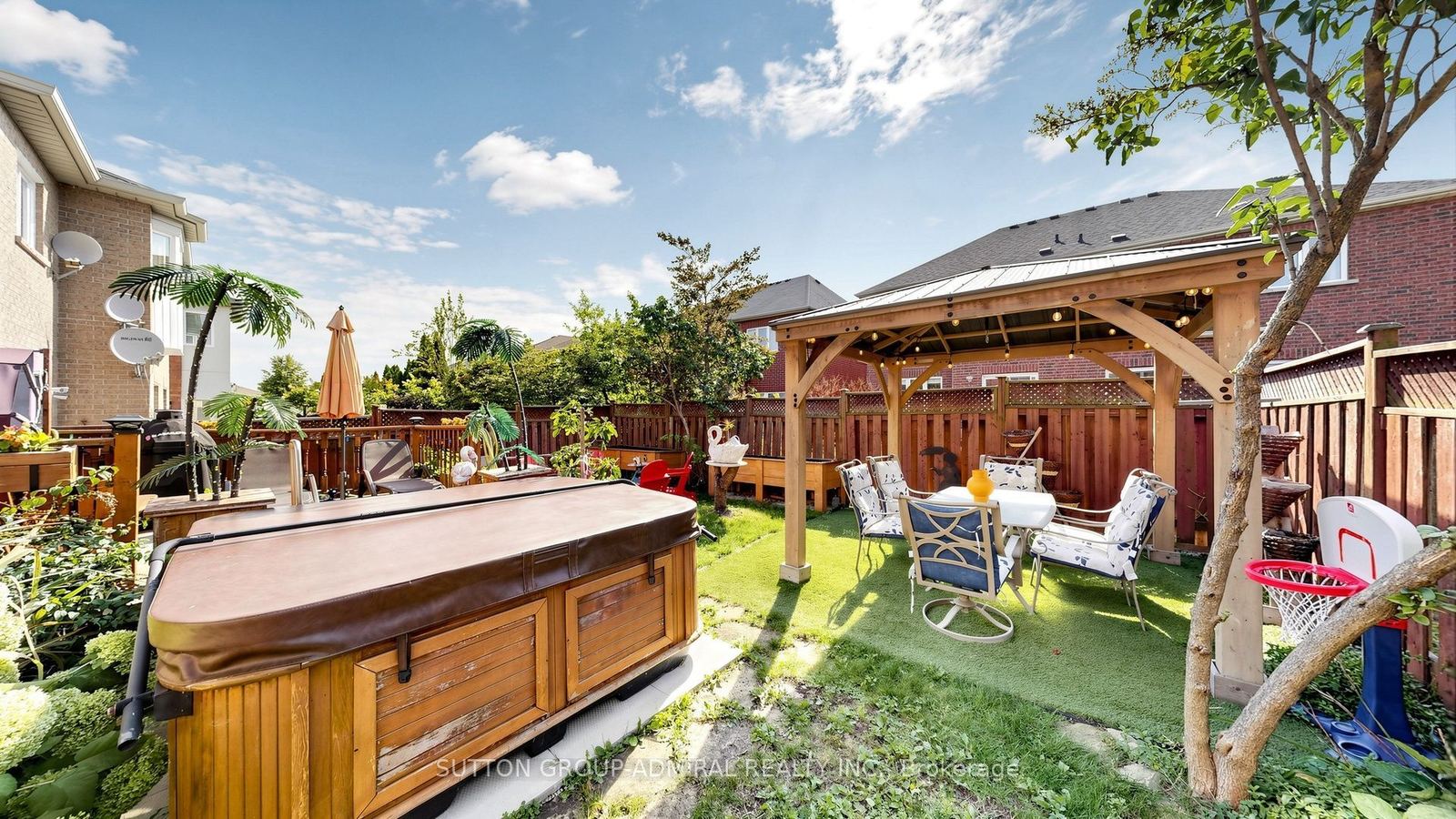 Backyard with cedar gazebo, hot tub and mature gardens