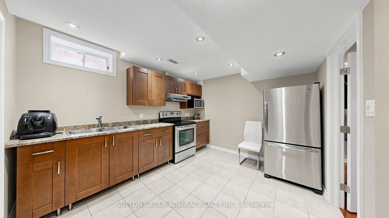 The lower-level second kitchen with full-size stainless appliances